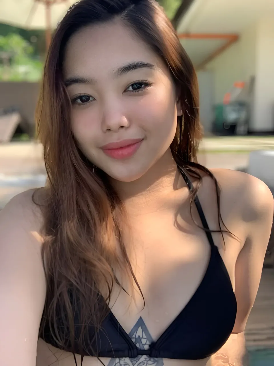 Angela May Bituin wearing black swimwear poses for a close-up portrait