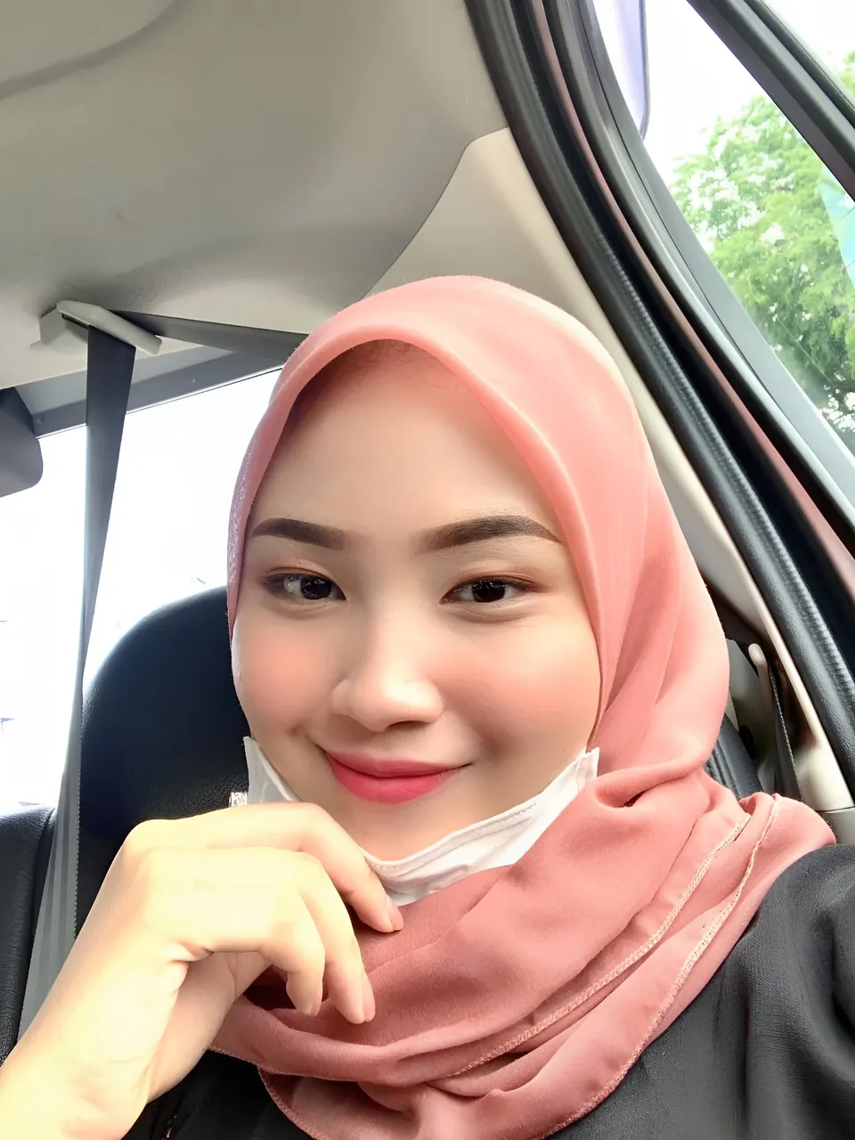 Bella Marlowe wearing pink hijab seated in car interior
