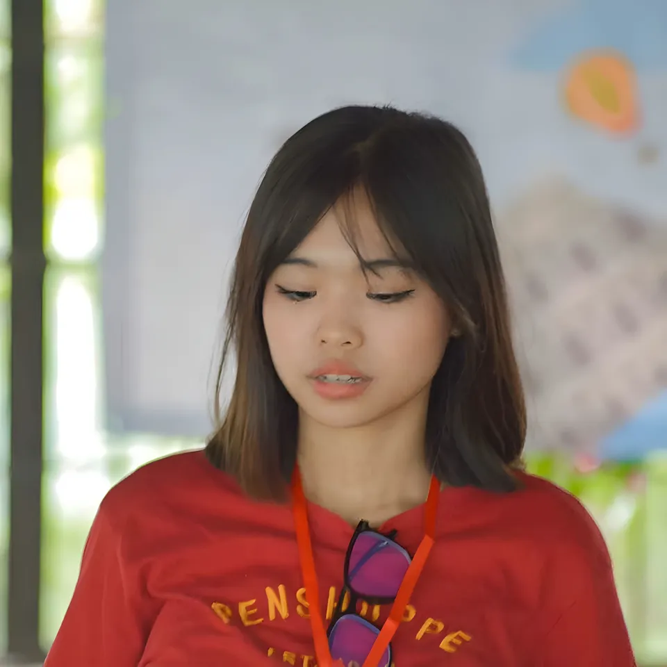 Beri Sinclair wearing red top with sunglasses on lanyard