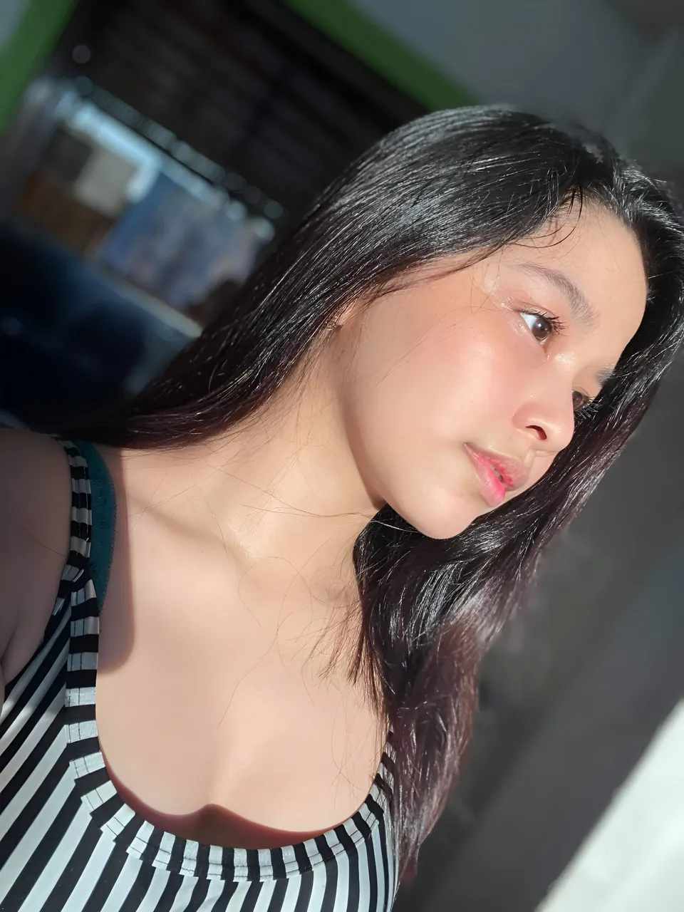 Callista Ray in striped top, close-up portrait, looking away from camera