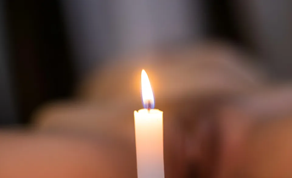 Cariza Tiglao — A single lit candle appears against a softly blurred background