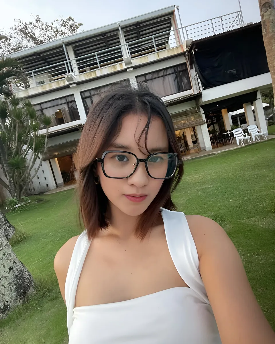 Cassidy Rowan wearing glasses and white top outdoors in front of building