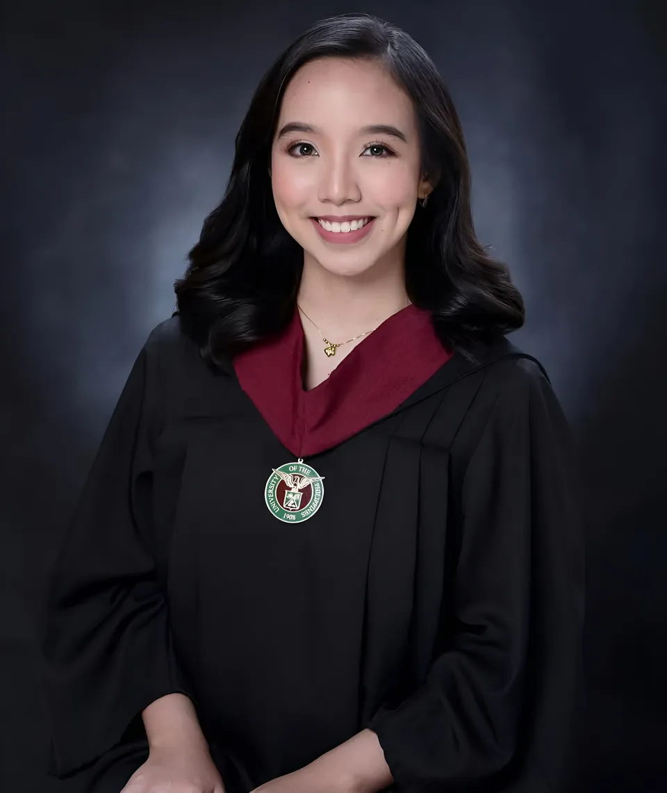 Clairee Winslow wearing a black gown with a red collar poses against a dark background