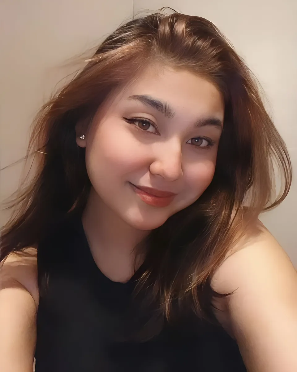Danisha Vale with long brown hair smiling in close-up selfie