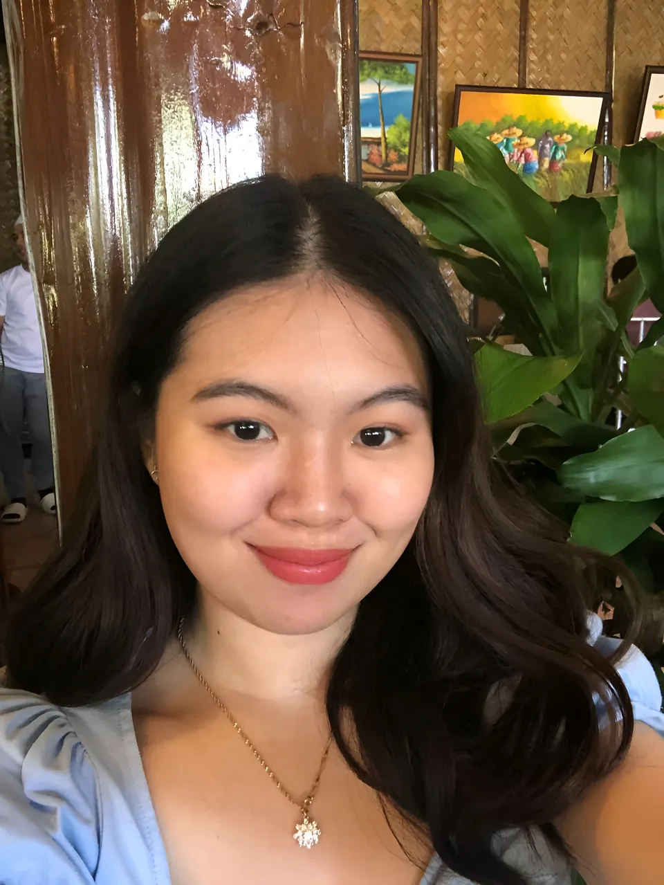 Erica Kyle smiling in light blue top with necklace