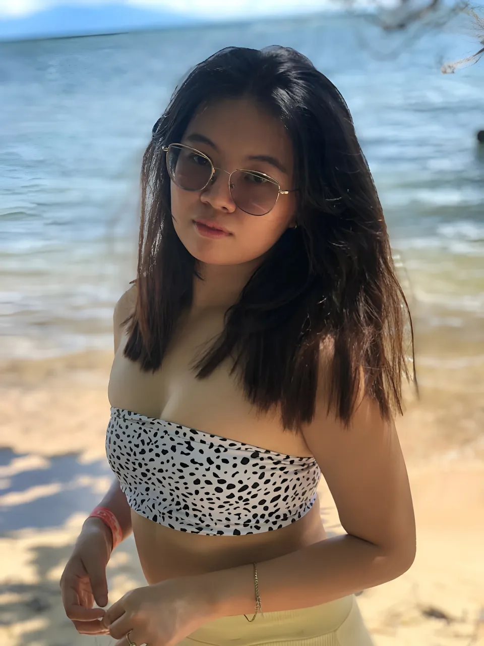 Erica Kyle wearing spotted top standing on beach
