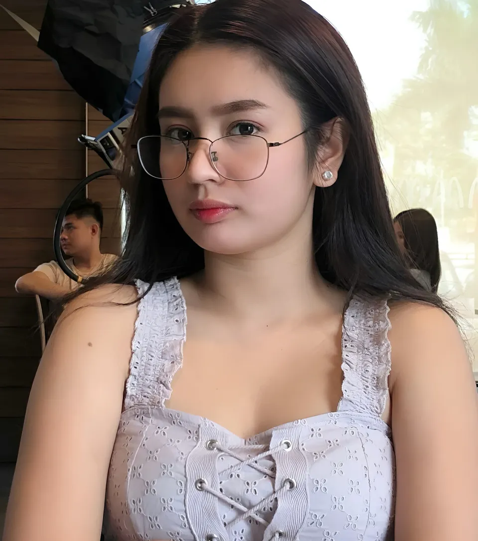Eunice Lois wearing glasses and white top in indoor setting