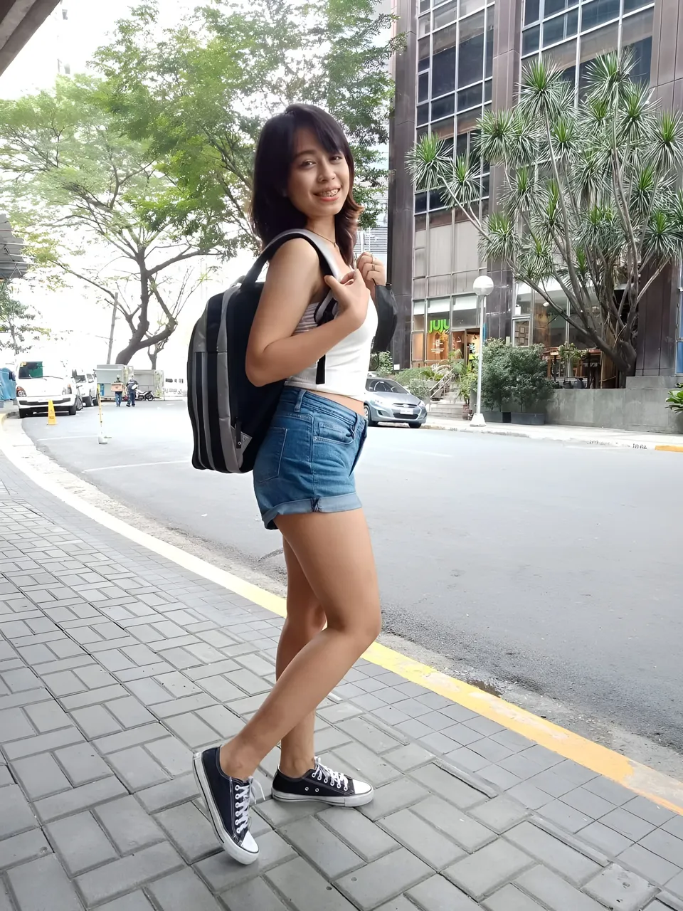 Francesca Ysabelle standing on sidewalk wearing backpack and shorts