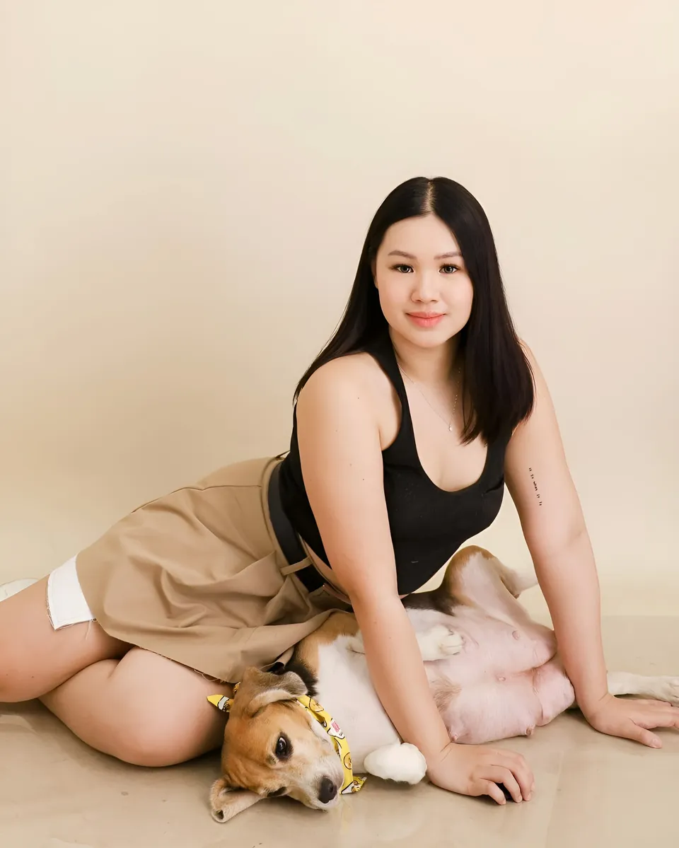 Genelleen Brooks and dog lying on floor together