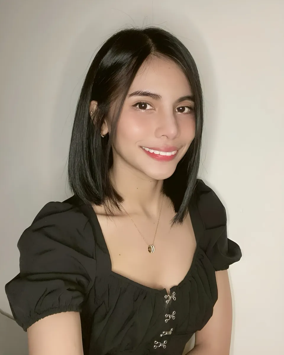 Ica Caparas in black top with puff sleeves and necklace