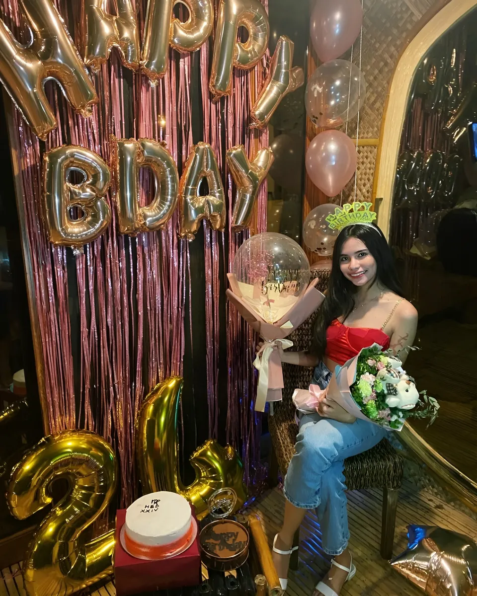 Ica Caparas seated with birthday decorations and balloons