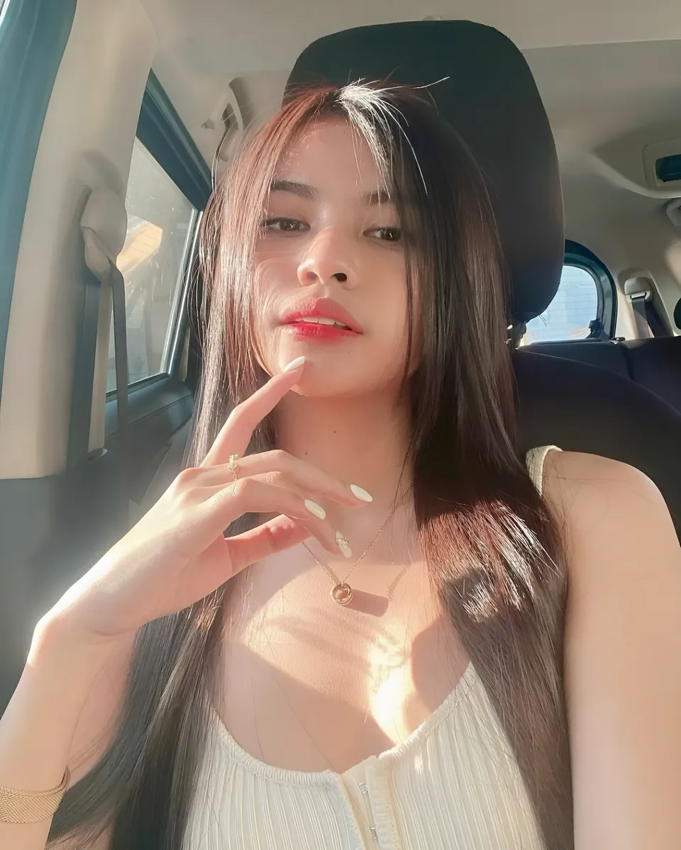 Ica Caparas in white top seated in car with hand near face