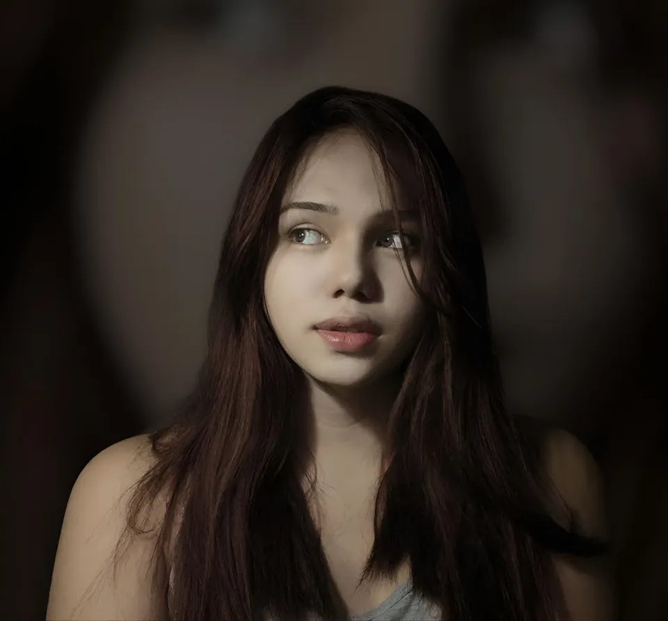 Irish Cruz with long dark hair in dimly lit portrait setting