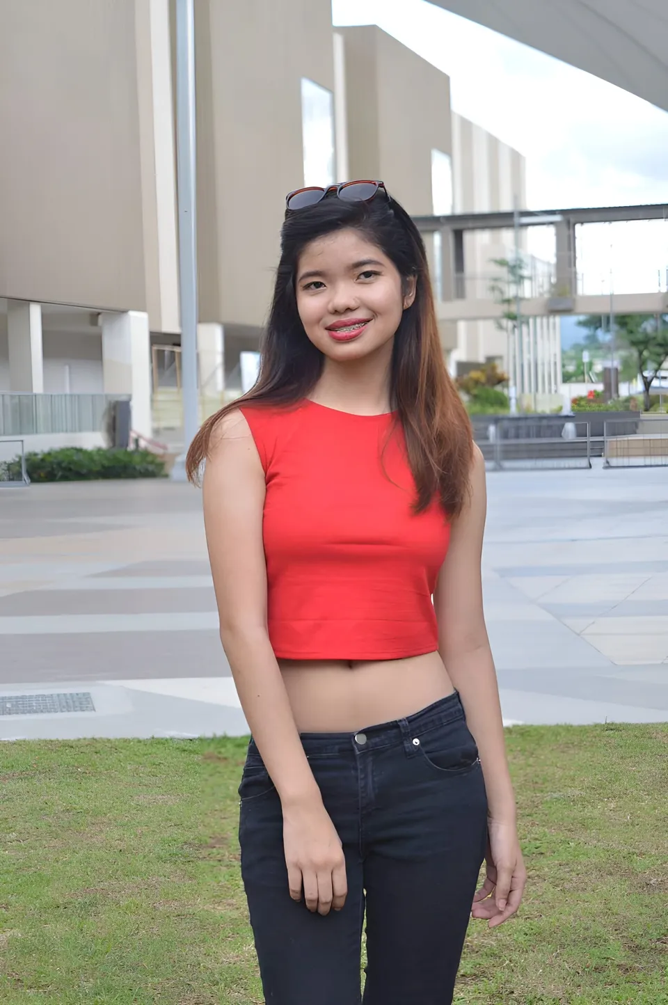 Jann Tiffany Mendoza in red crop top and dark jeans standing outdoors