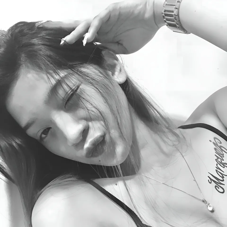 Jaymie Vale with hand near head wearing black top