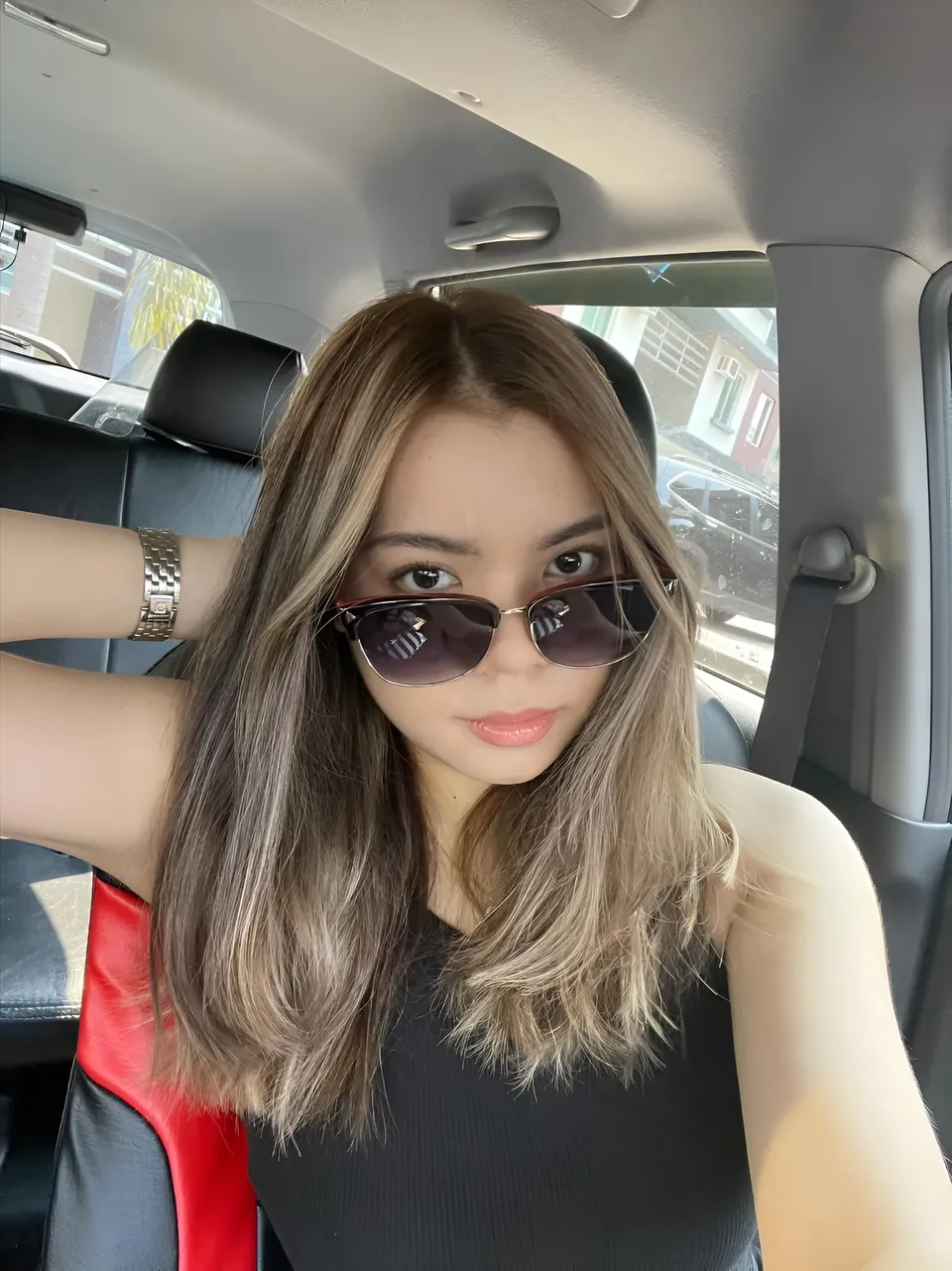 Jeanine Fernandez wearing sunglasses seated in car interior