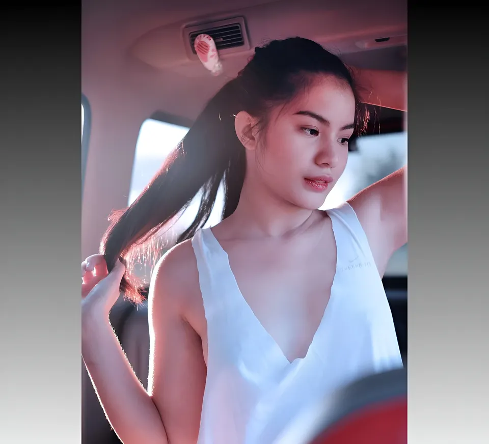Jennieva Quinn in white top seated inside vehicle