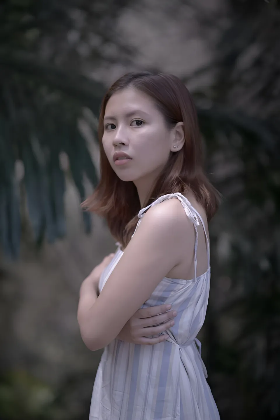 Jessa Bariuan in striped dress standing outdoors with arms crossed