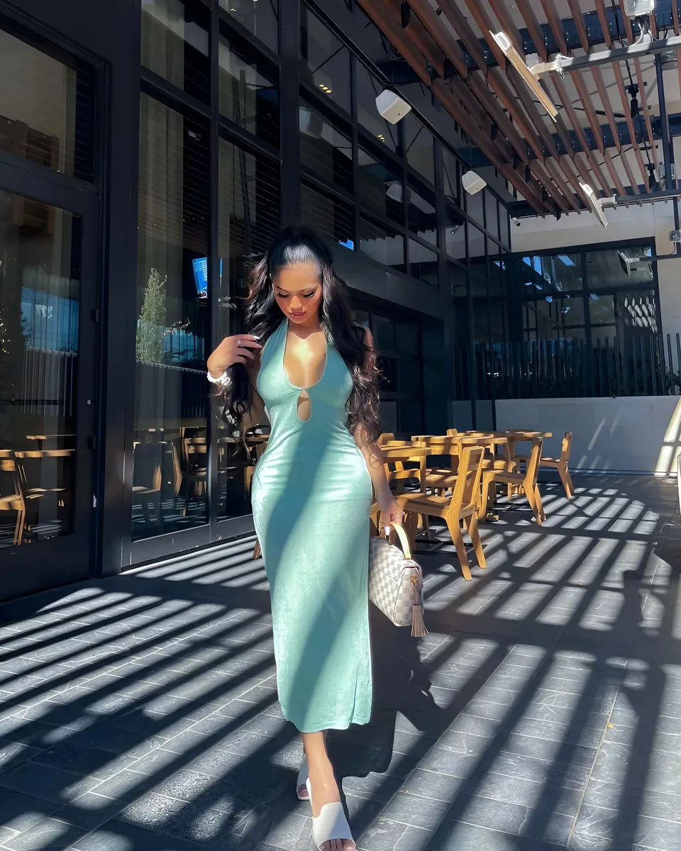 Joey Nerosa in mint green dress standing on tiled patio