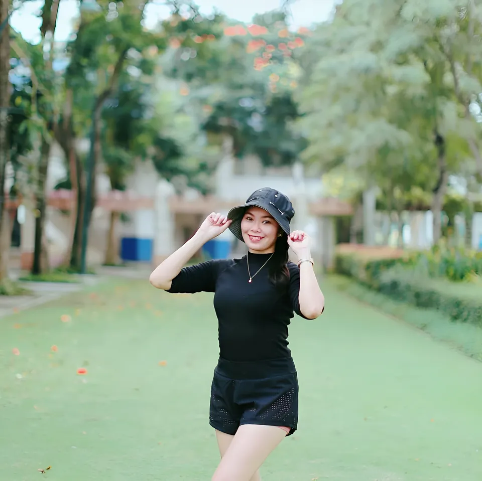 Joyme Magalona in black outfit standing on green path outdoors
