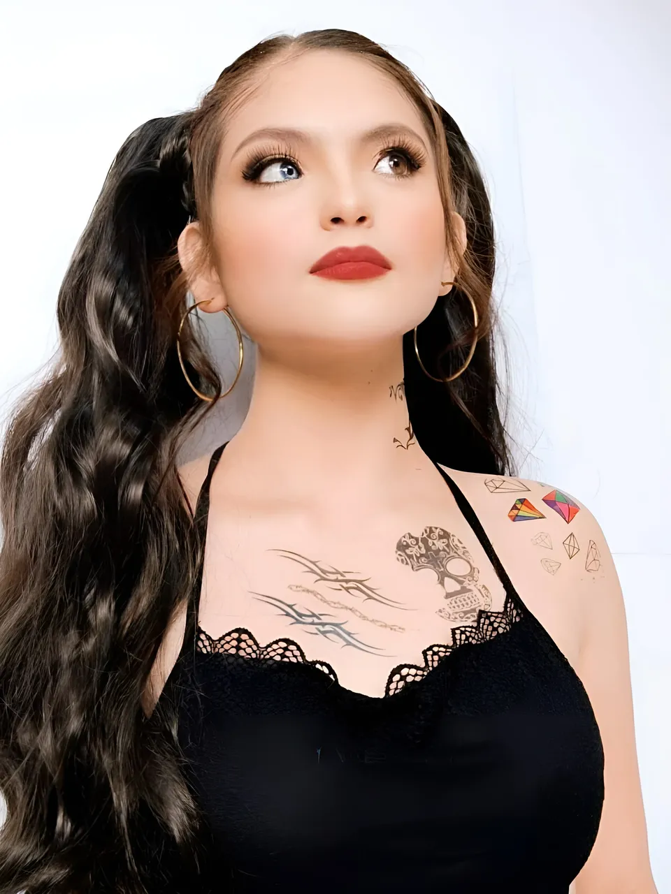 Julia Ostan in black lace top with visible tattoos on chest and shoulder