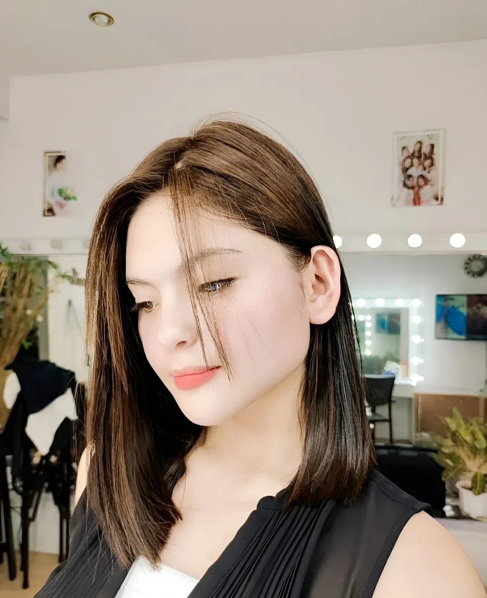 Julia Ostan in black top with shoulder-length hair in indoor setting