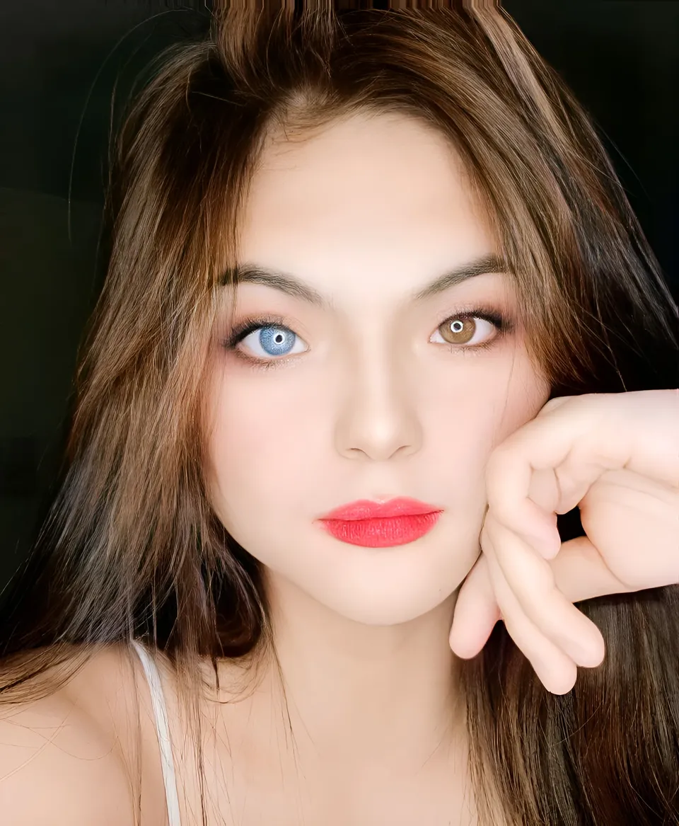 Julia Ostan with contrasting eye colors and red lips in close-up portrait