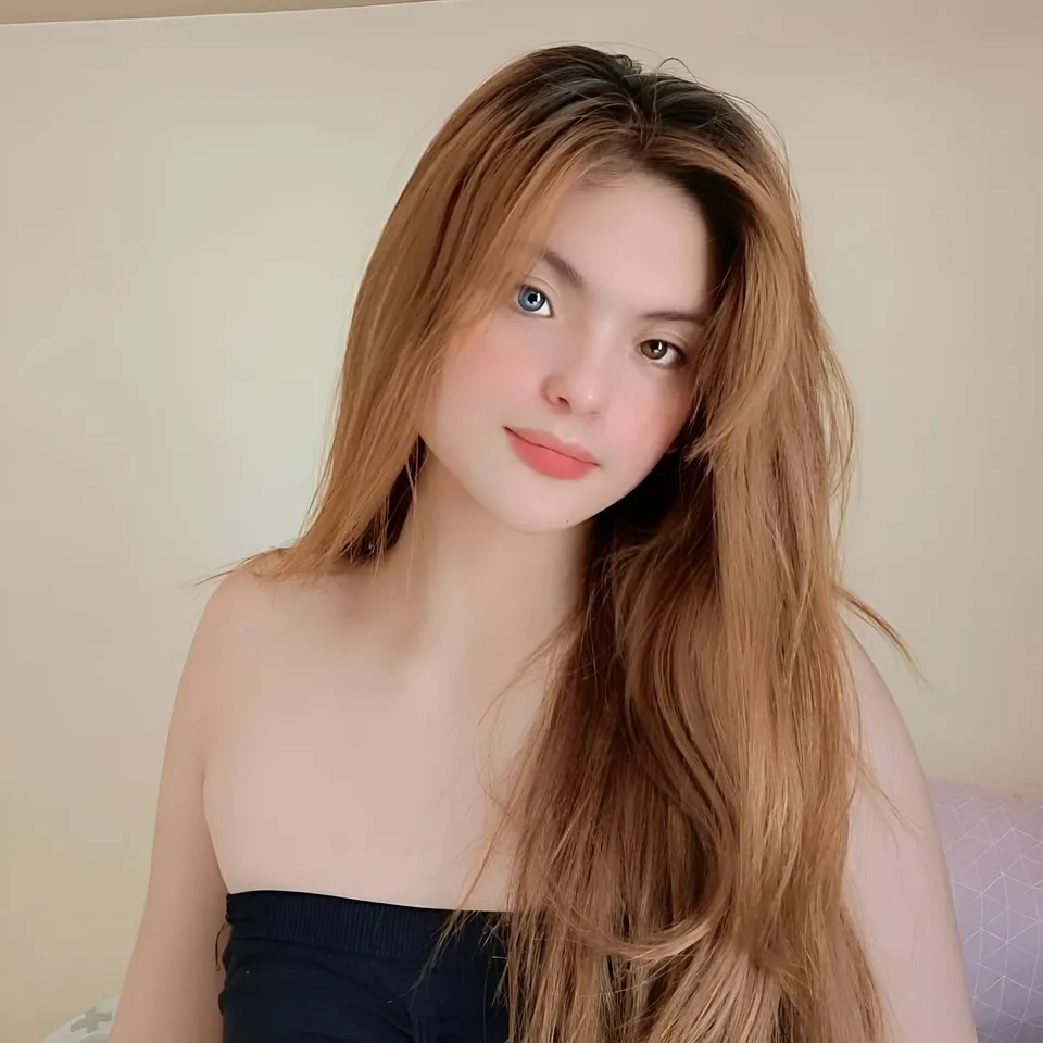 Julia Ostan with long hair wearing strap top in indoor setting