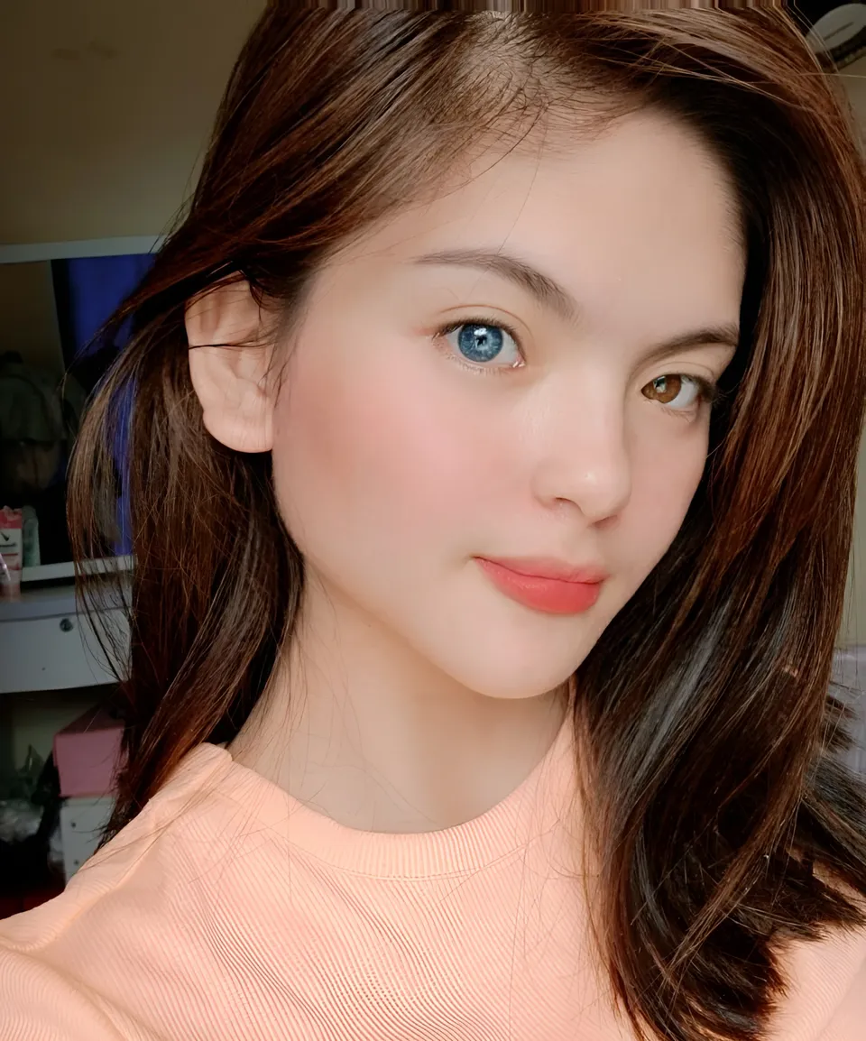 Julia Ostan in pink top with long brown hair in close-up portrait