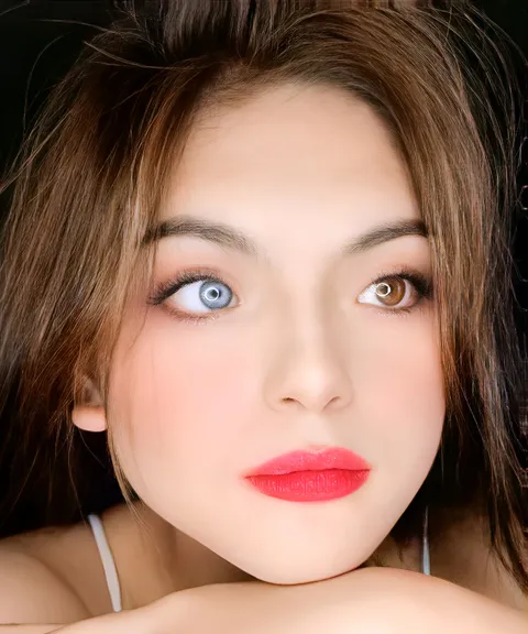 Julia Ostan — A close-up portrait shows a person wearing red lipstick with one hand beneath their chin