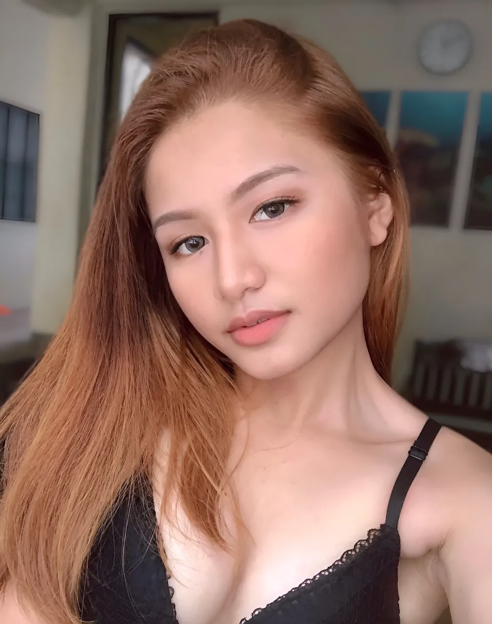 Krysta Matias in black lace top with long hair in close-up portrait