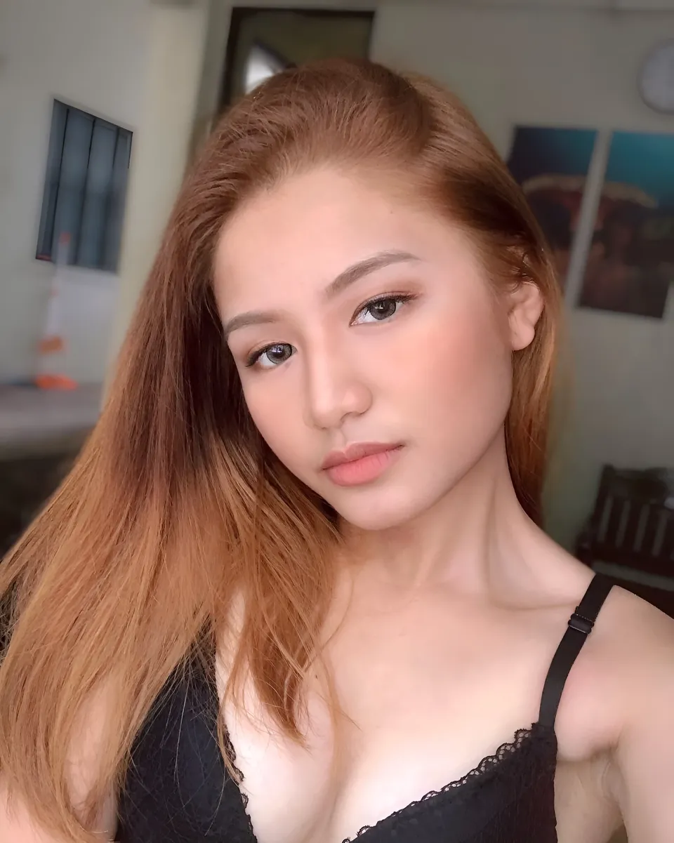 Krysta Matias with long hair wearing black top in indoor setting