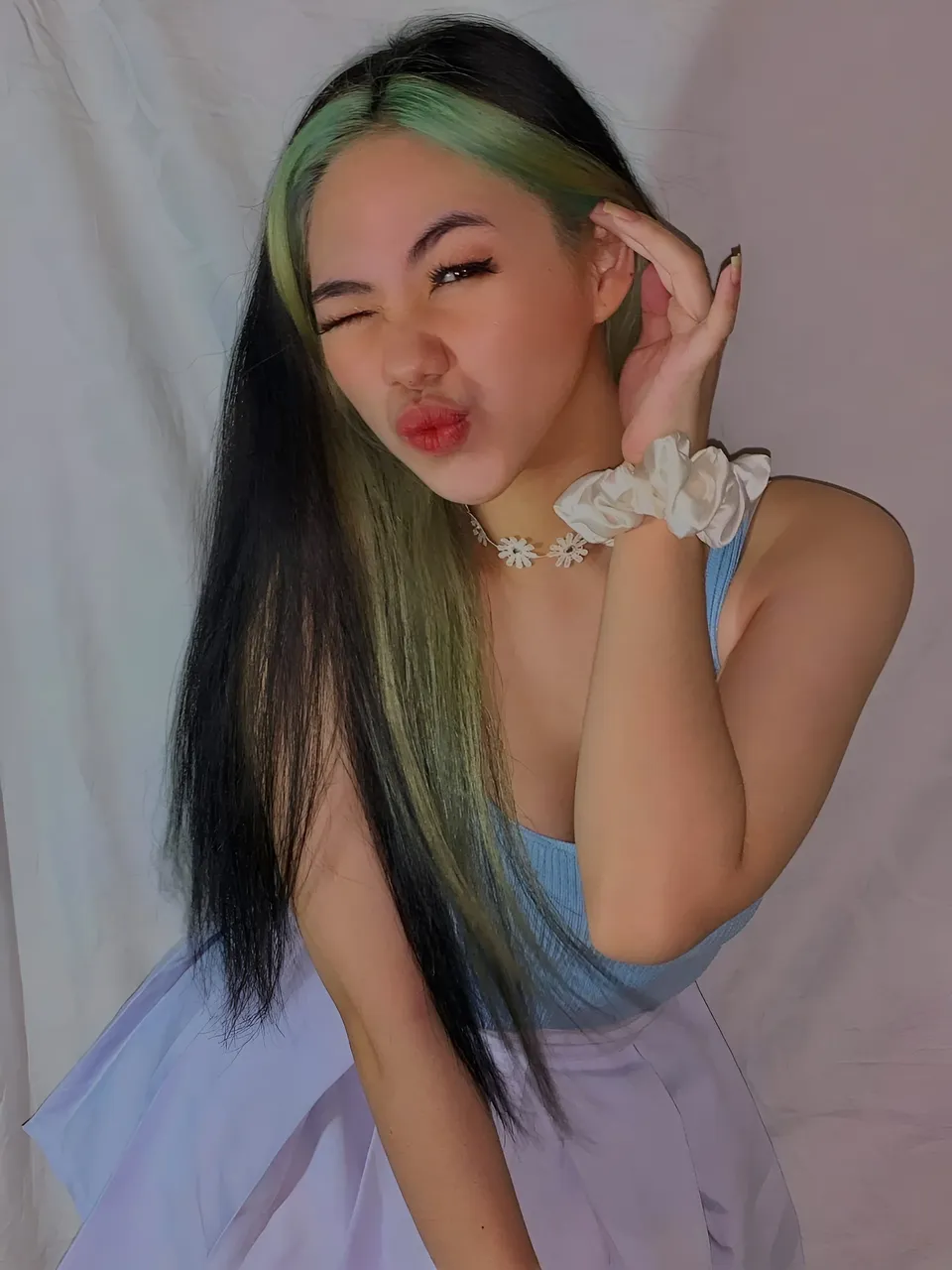 Kylene Santos with green hair wearing blue top and white skirt