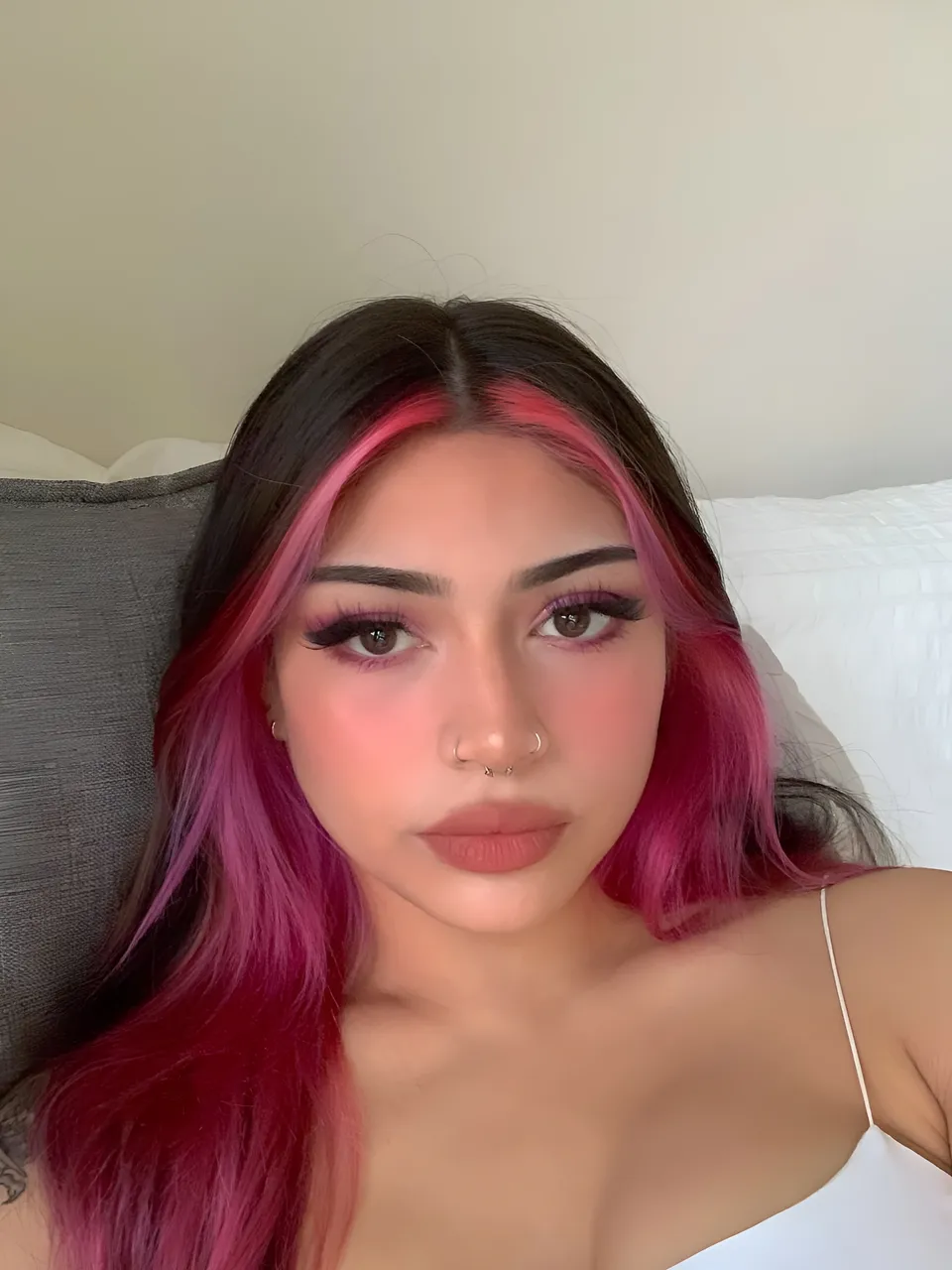 Lia Mae Vumbaca with pink hair and makeup in close-up portrait