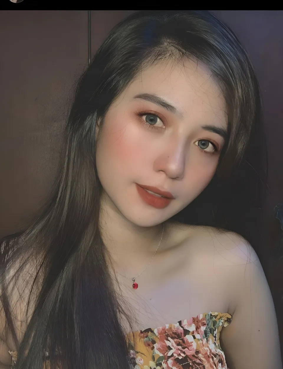 Mae Roxas in floral top with necklace in close-up portrait