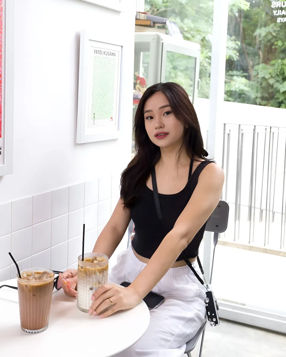 Maeve Linden seated at table with two iced drinks