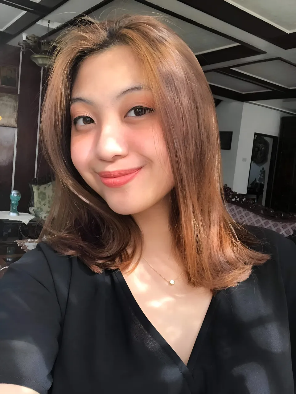Mariah Protacio in black top with shoulder-length hair in indoor setting