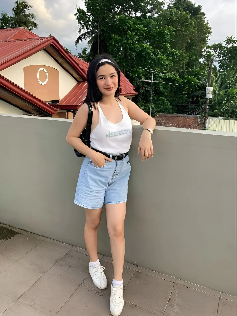 Mary Darnyl Bondad in white top and light blue shorts standing outdoors