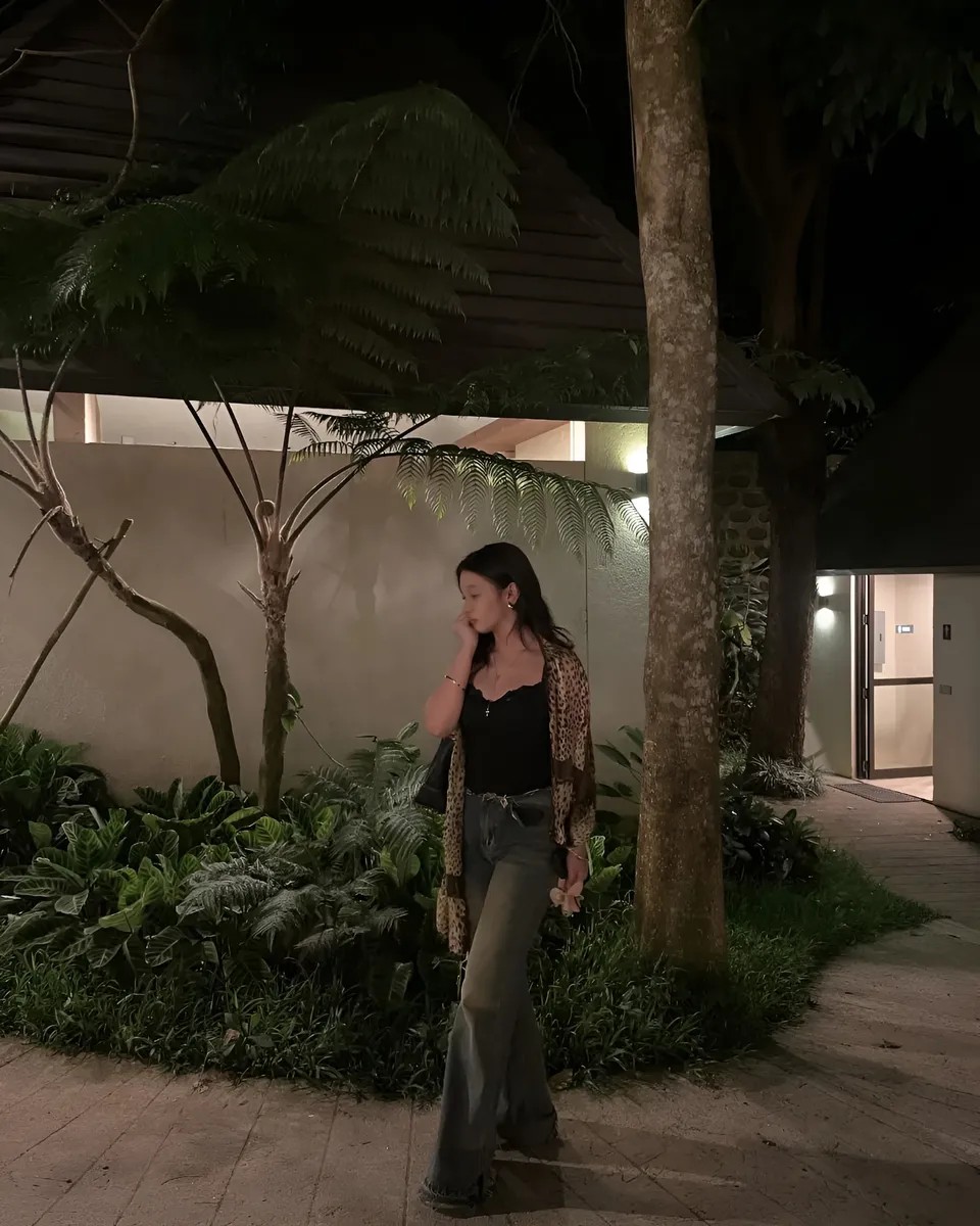 Maryshel Monroe standing outdoors at night near trees