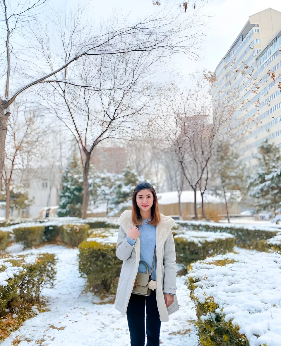Michelle Arden standing on snowy path with trees and buildings in background