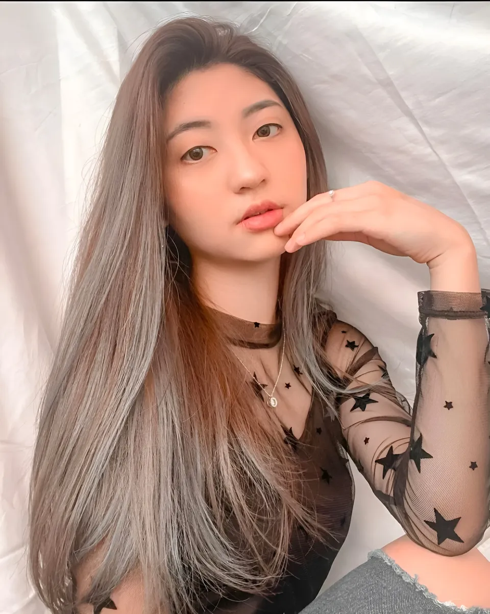 Michelle Arden in star-patterned sheer top with hand near face