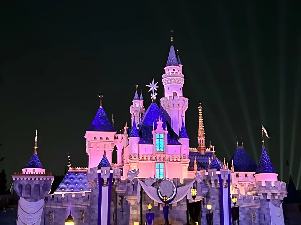 Mina Hartley — Castle illuminated with purple and blue lights at night