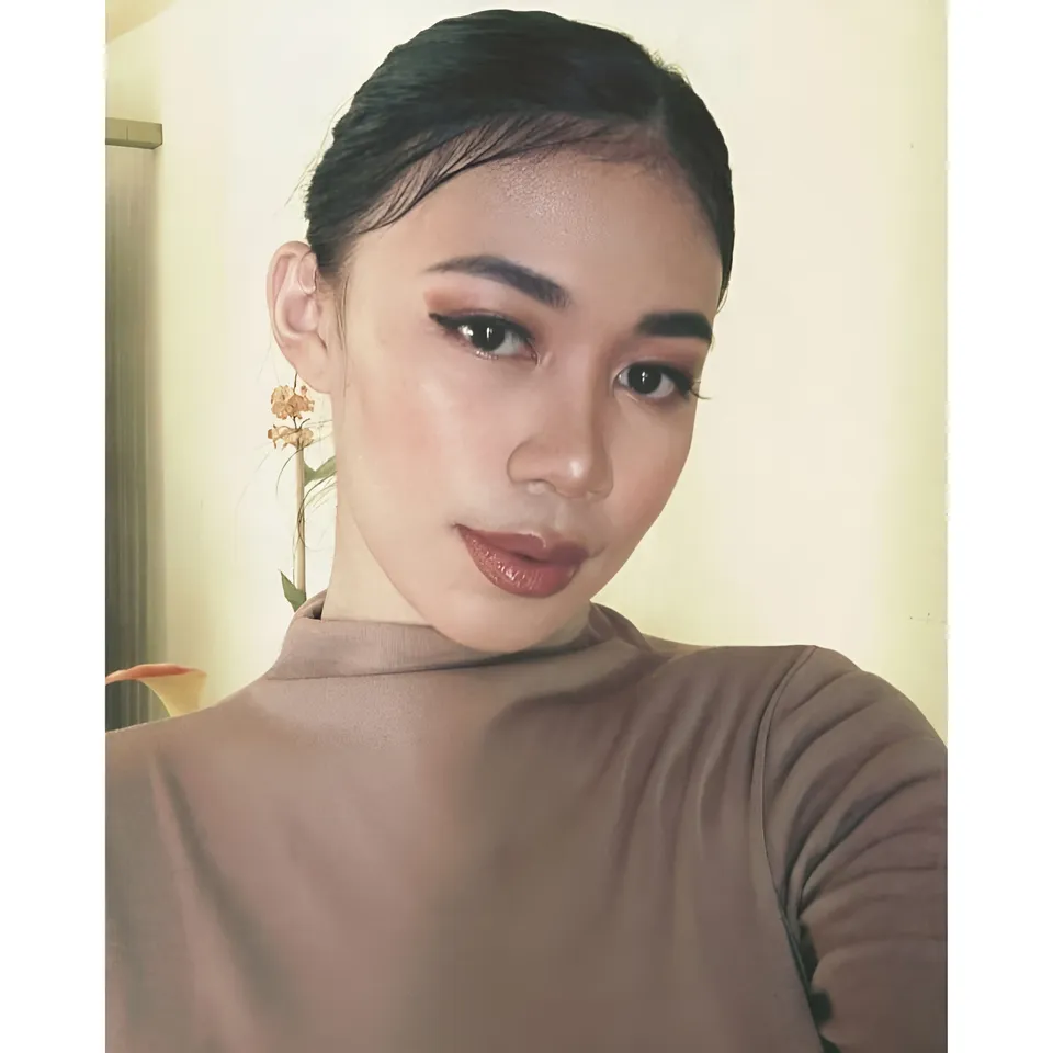 Moraya Ong in brown top with dark hair pulled back