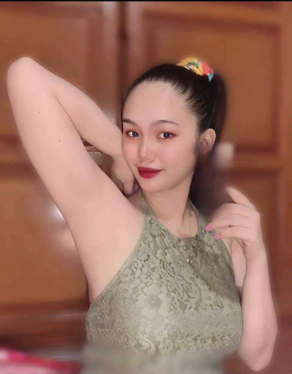 Nica Gueverra in green lace top with hair tied back