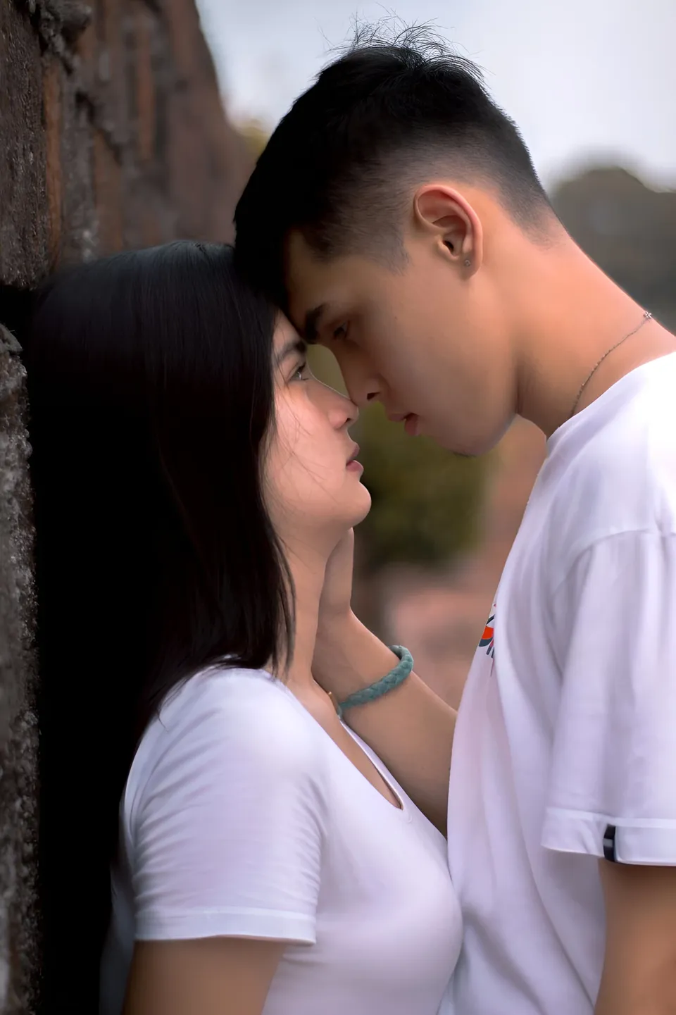 Oshley Apostol — Two people wearing white shirts face each other closely