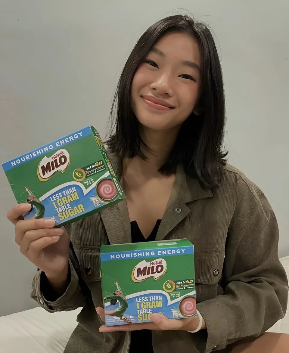 Pia Idelfonso holding two green and blue Nestlé Milo boxes