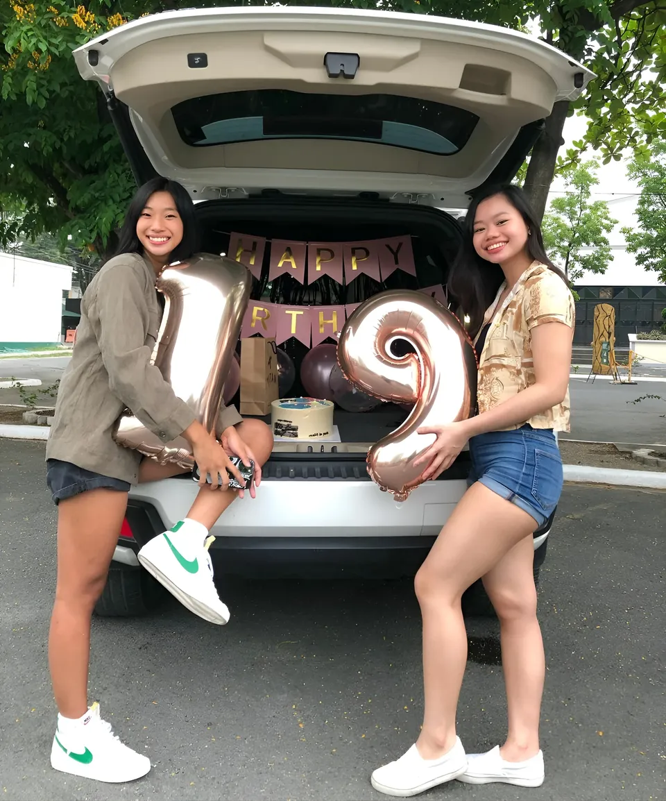 Pia Idelfonso — Two people holding large number balloons in front of open car trunk