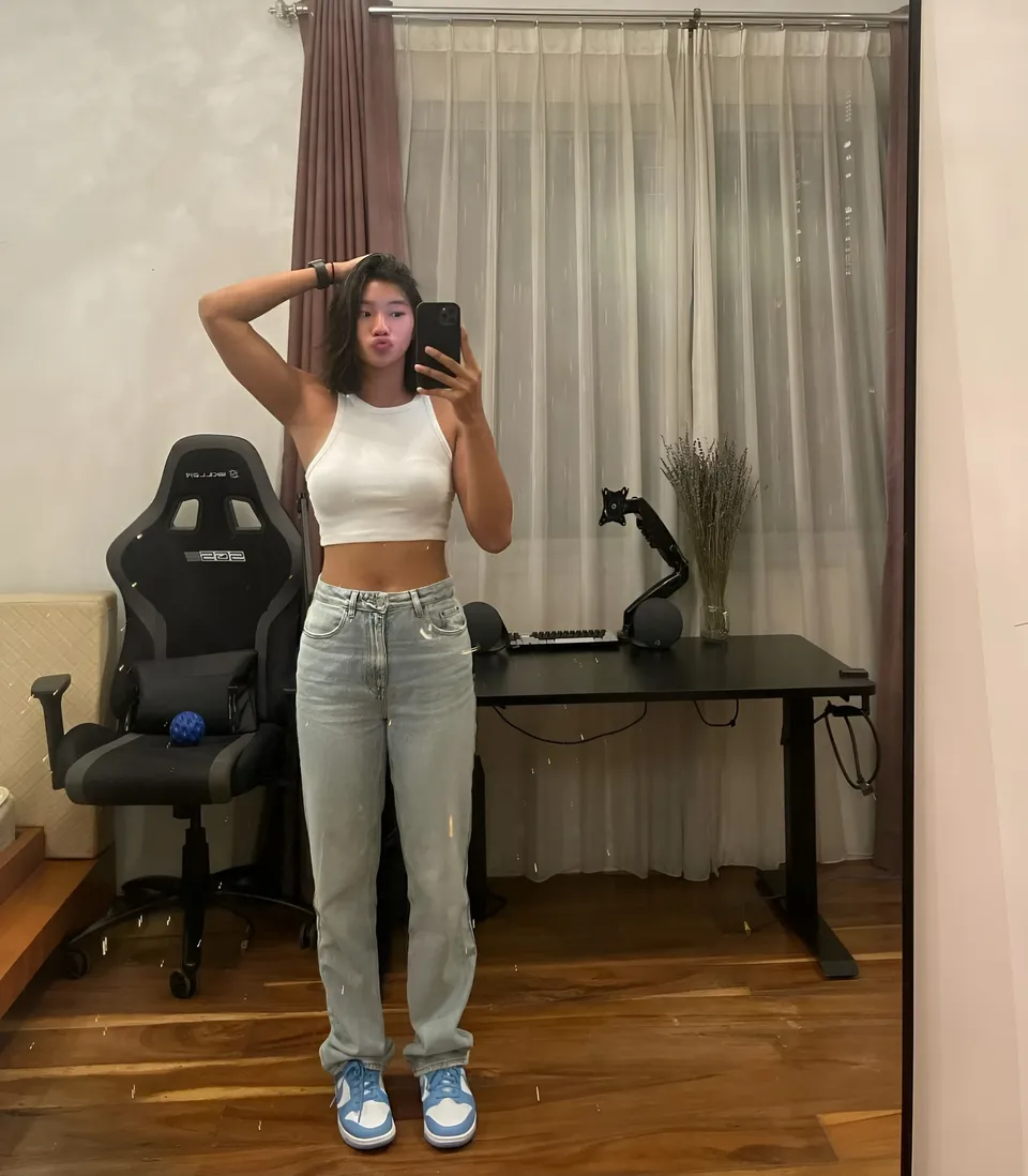 Pia Idelfonso taking mirror selfie in white top and jeans