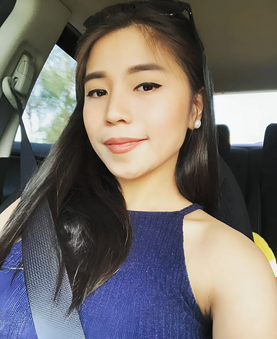 Princess Reyes in blue top seated in car