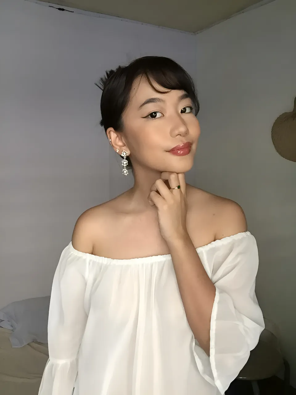 Ramoana Sinclair in white off-shoulder top posing indoors